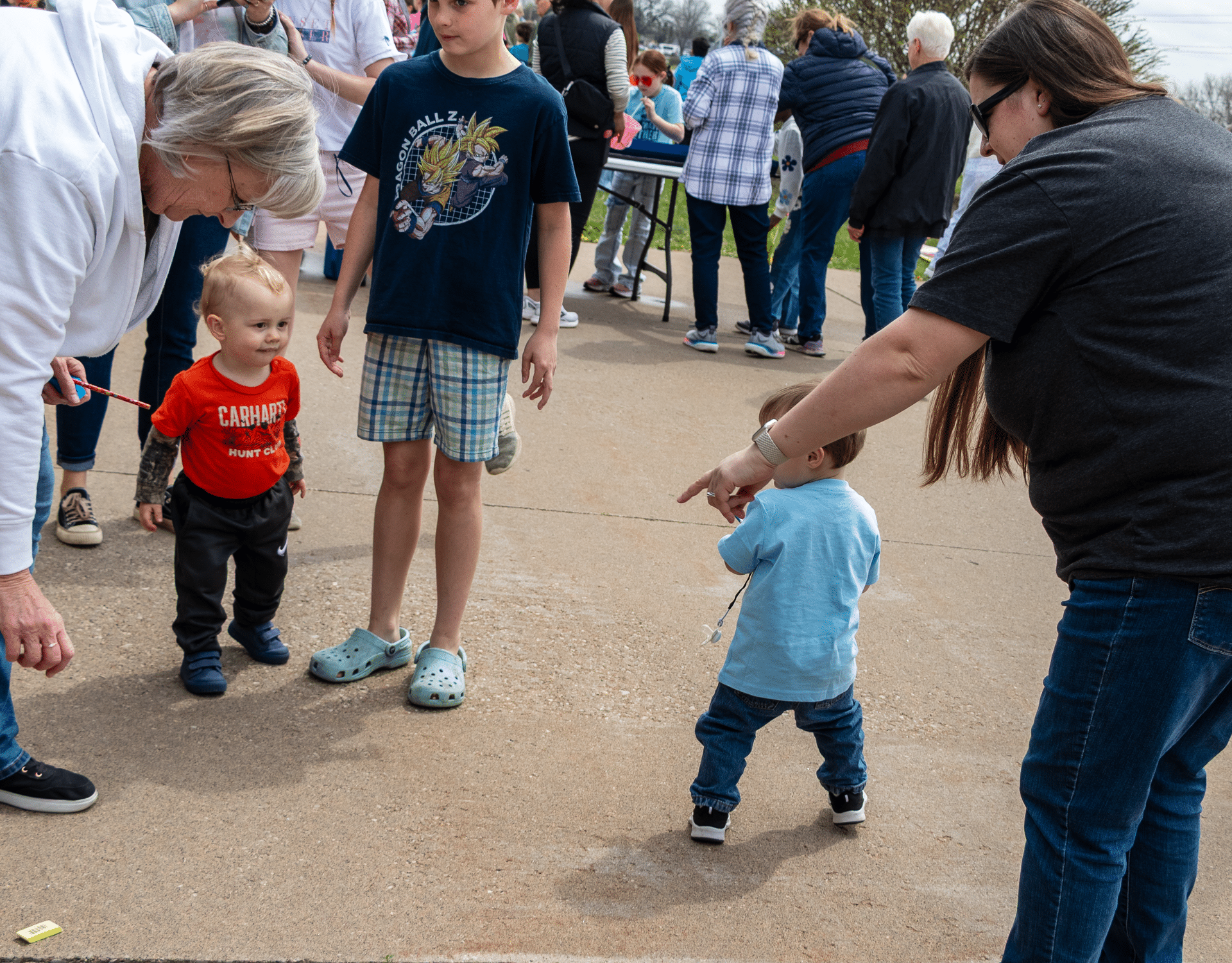 Families and children gather outside, sharing smiles and hope in our welcoming church community. - Muscatine Church of Christ