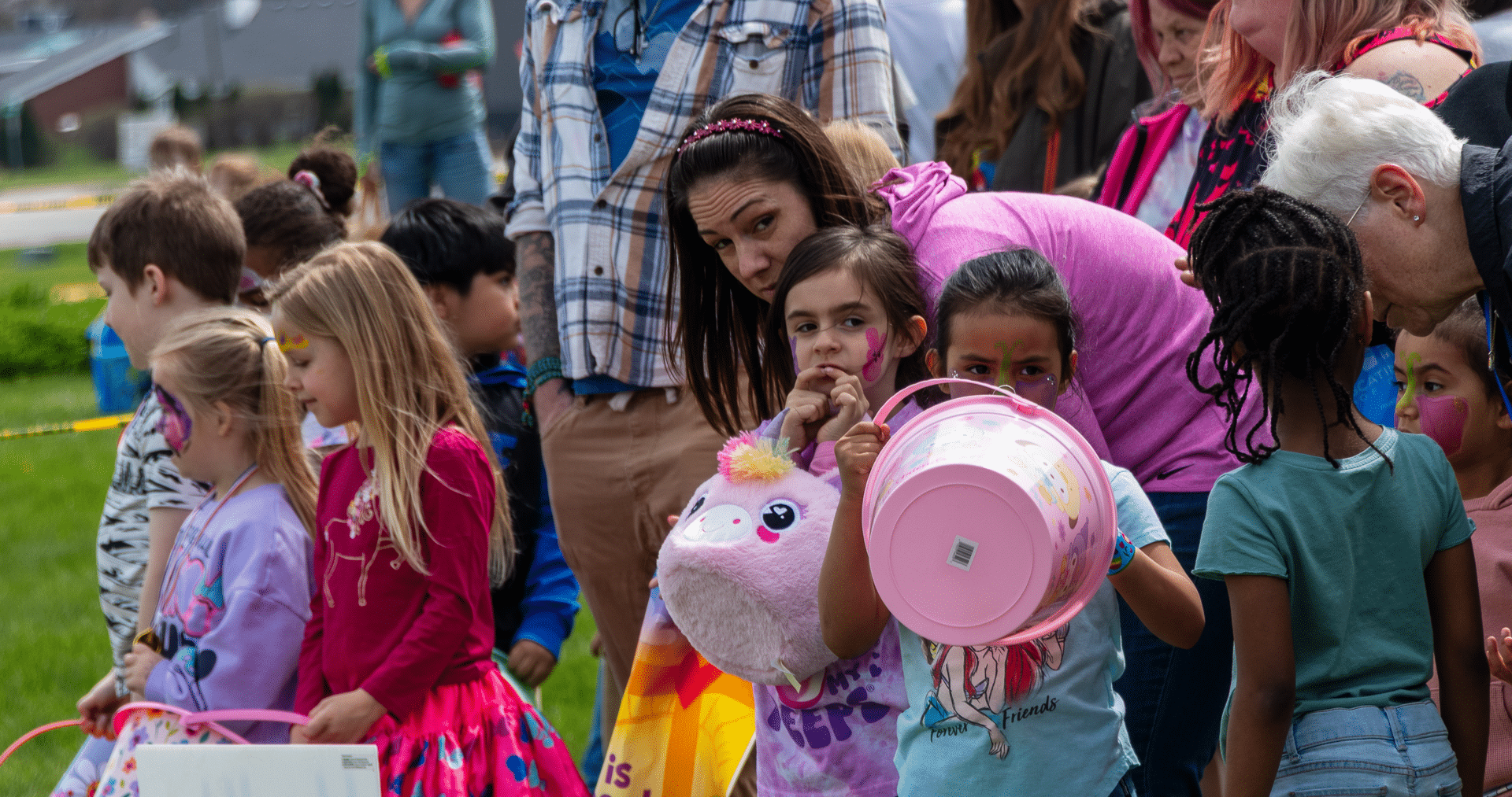 Families and children gather outside with buckets and smiles, ready for a joyful, hope-filled time together. - Muscatine Church of Christ