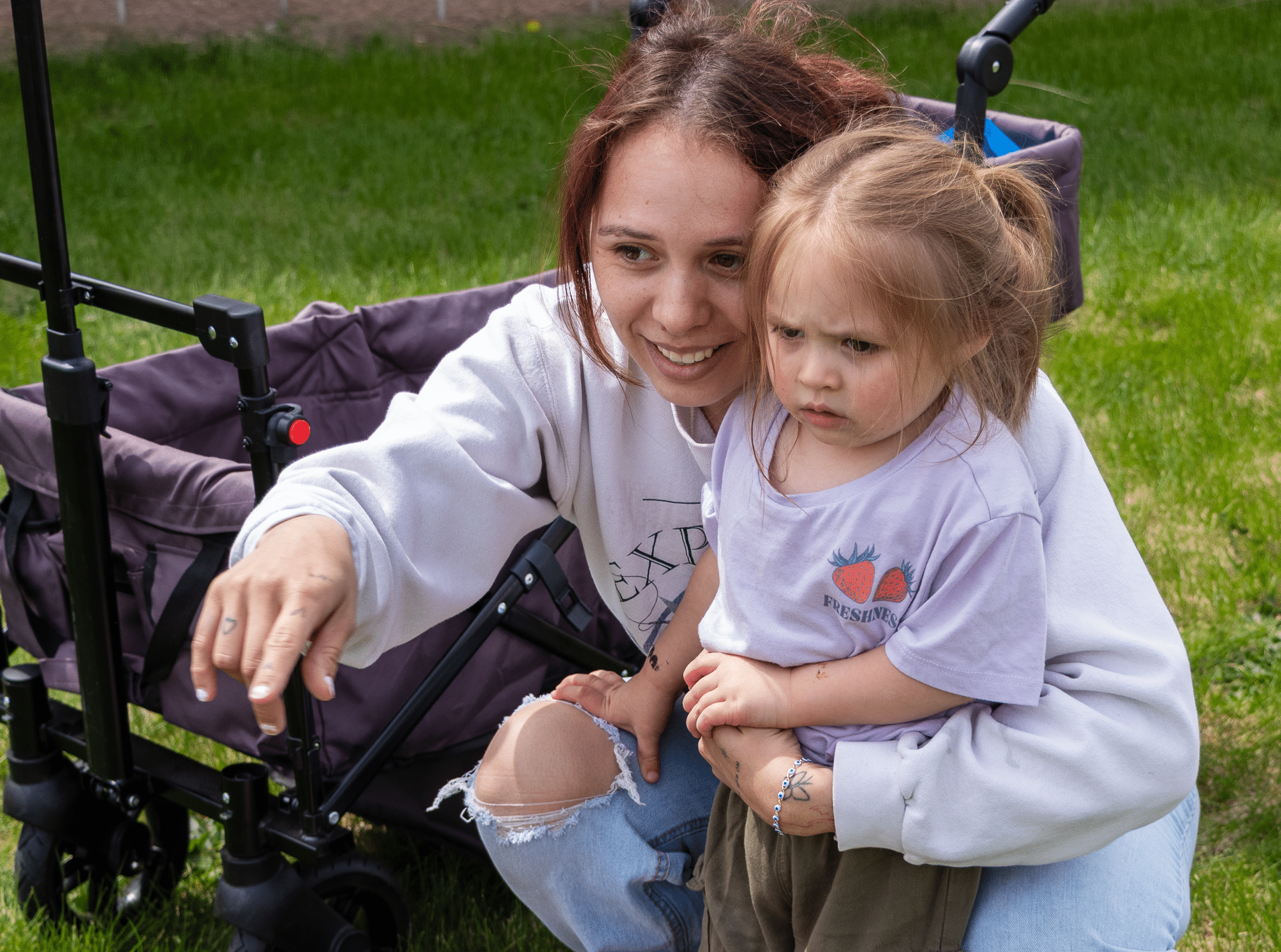A caring adult welcomes a child outside, sharing hope and community on a bright day at Muscatine Church of Christ. - Muscatine Church of Christ