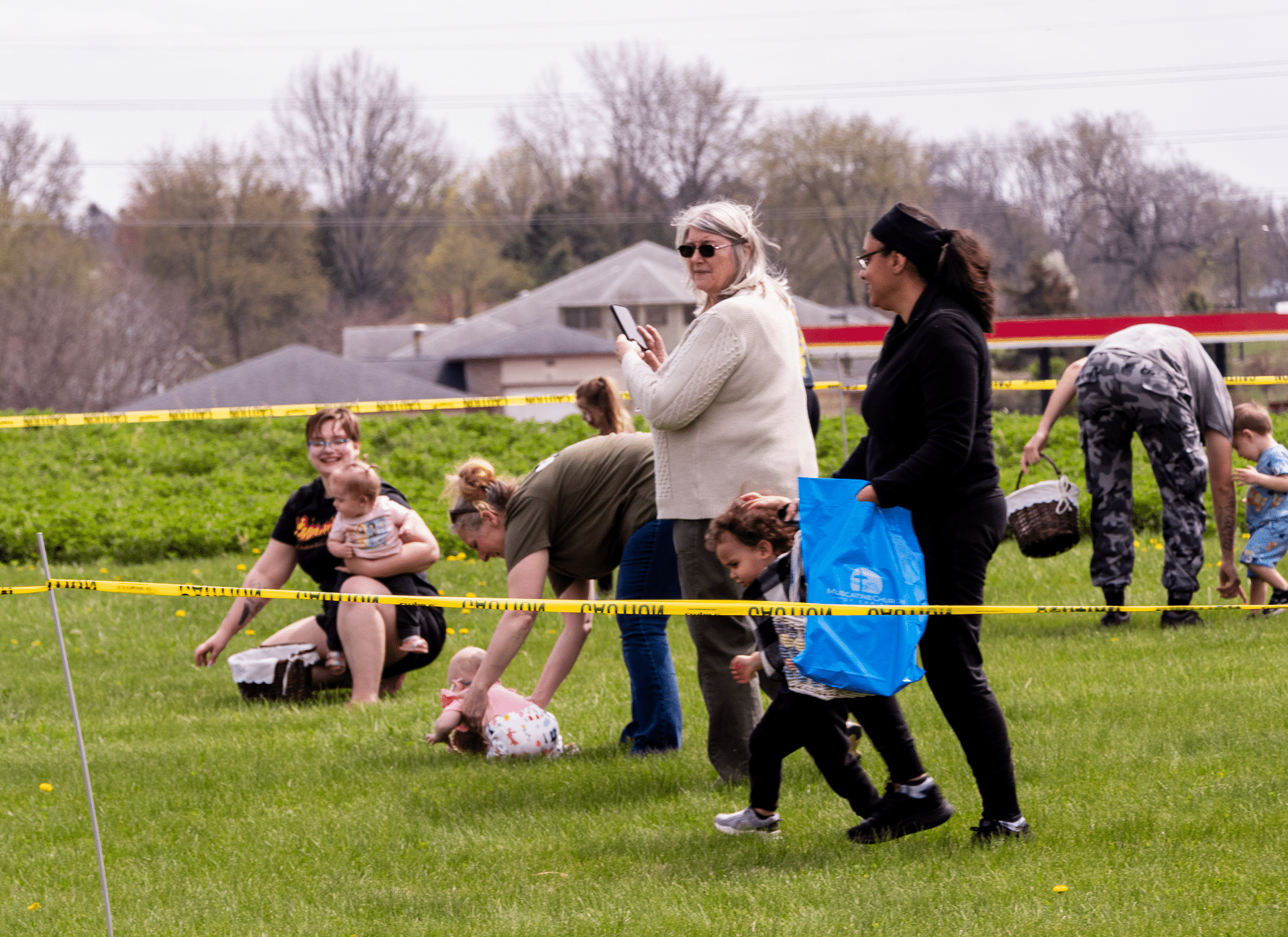 Families and friends joyfully gather outdoors, sharing smiles and hope as they join in a welcoming community event. - Muscatine Church of Christ