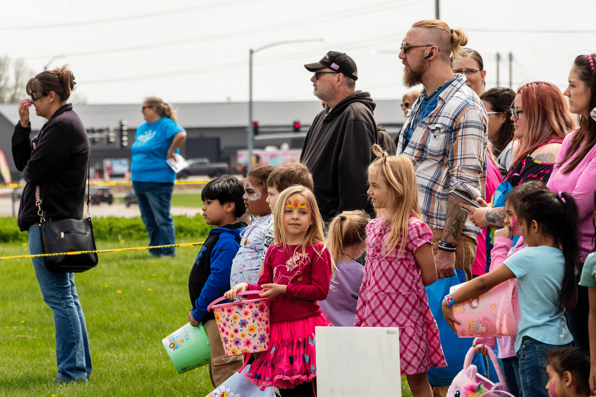 Families and children gather on the grass with bright smiles, baskets in hand—everyone welcome to share hope and joy. - Muscatine Church of Christ