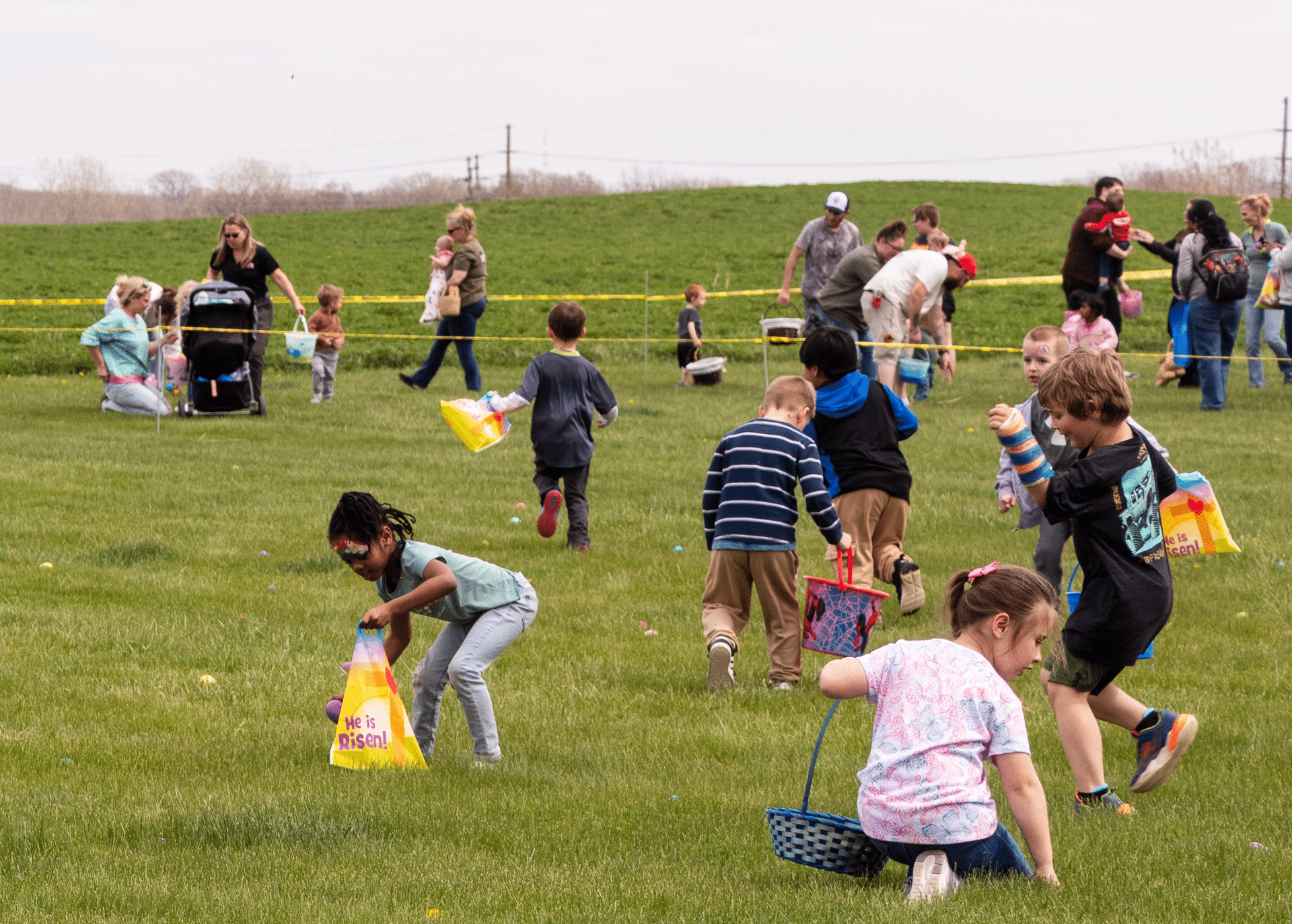 Kids enjoy a joyful egg hunt outdoors, sharing smiles as our church family cheers them on with warmth and hope. - Muscatine Church of Christ