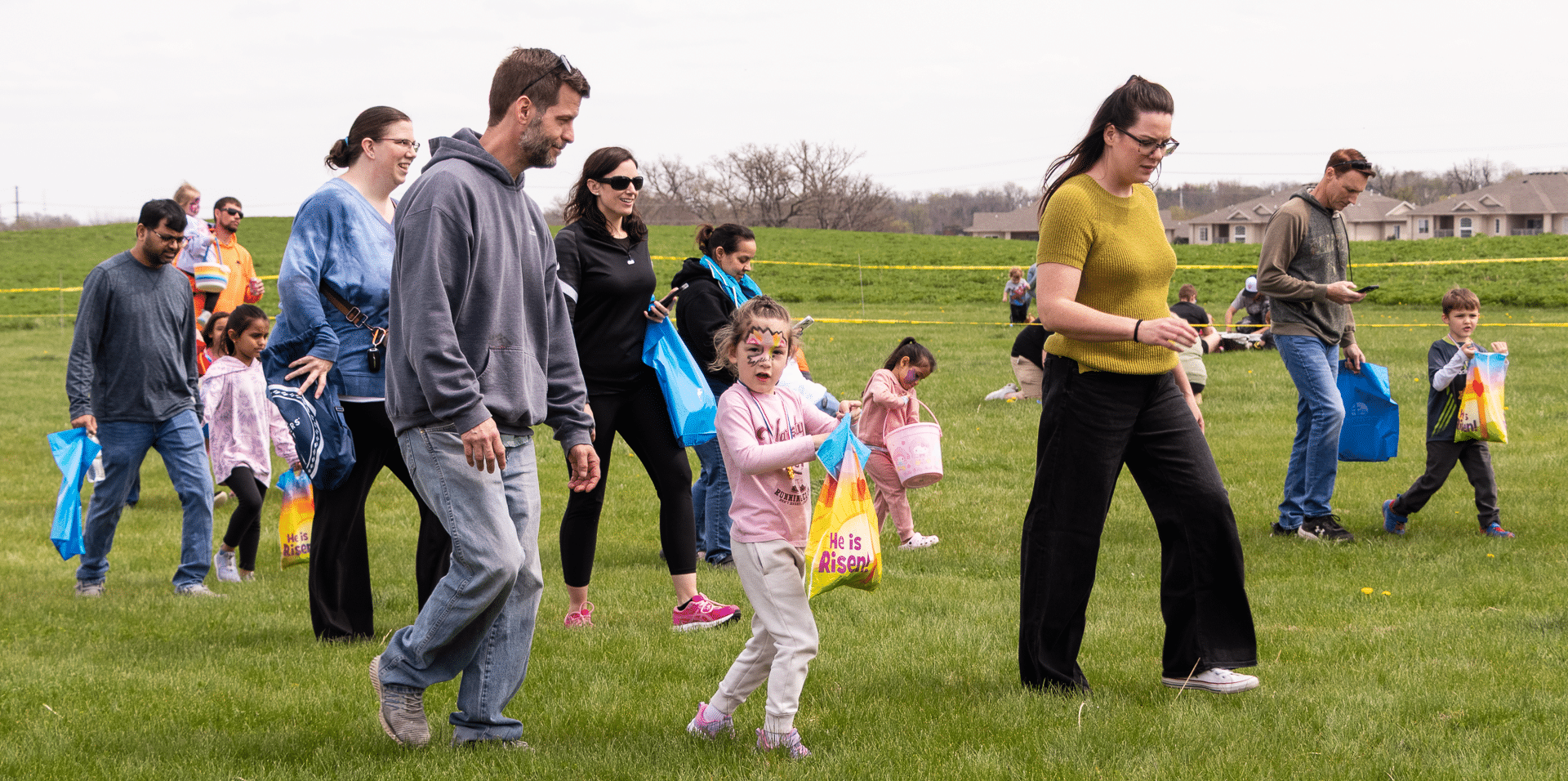 Families and friends share smiles and laughter outdoors, gathering with hope and joy at our church community event. - Muscatine Church of Christ