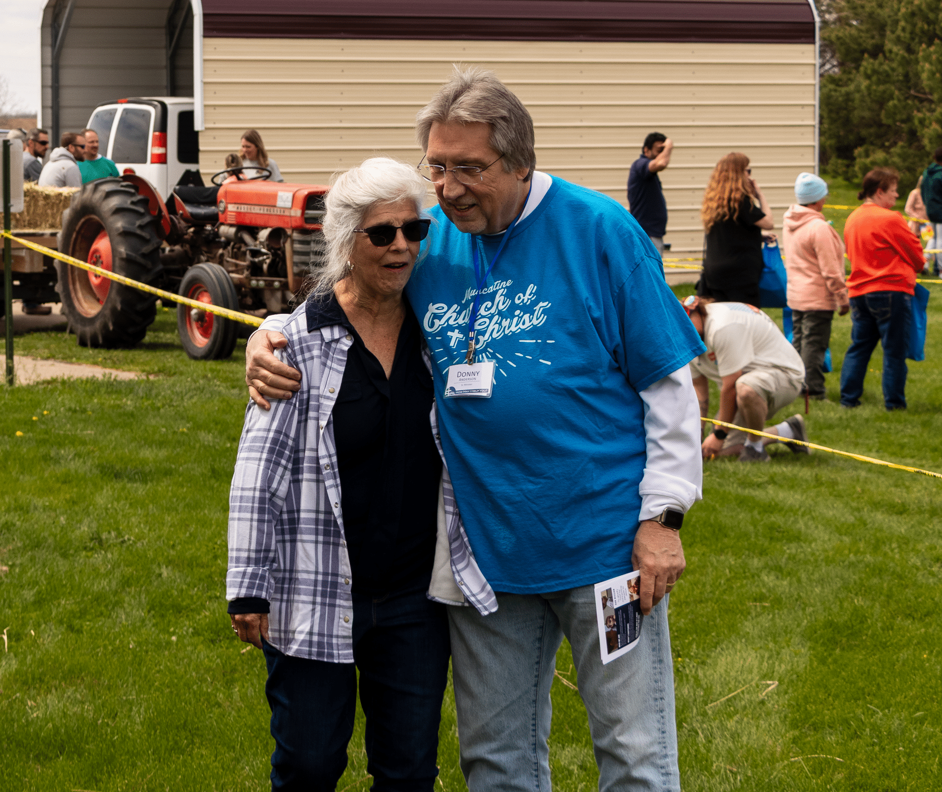 An older couple stands together on the grass, smiling warmly—reminding us all of hope, welcome, and shared community. - Muscatine Church of Christ