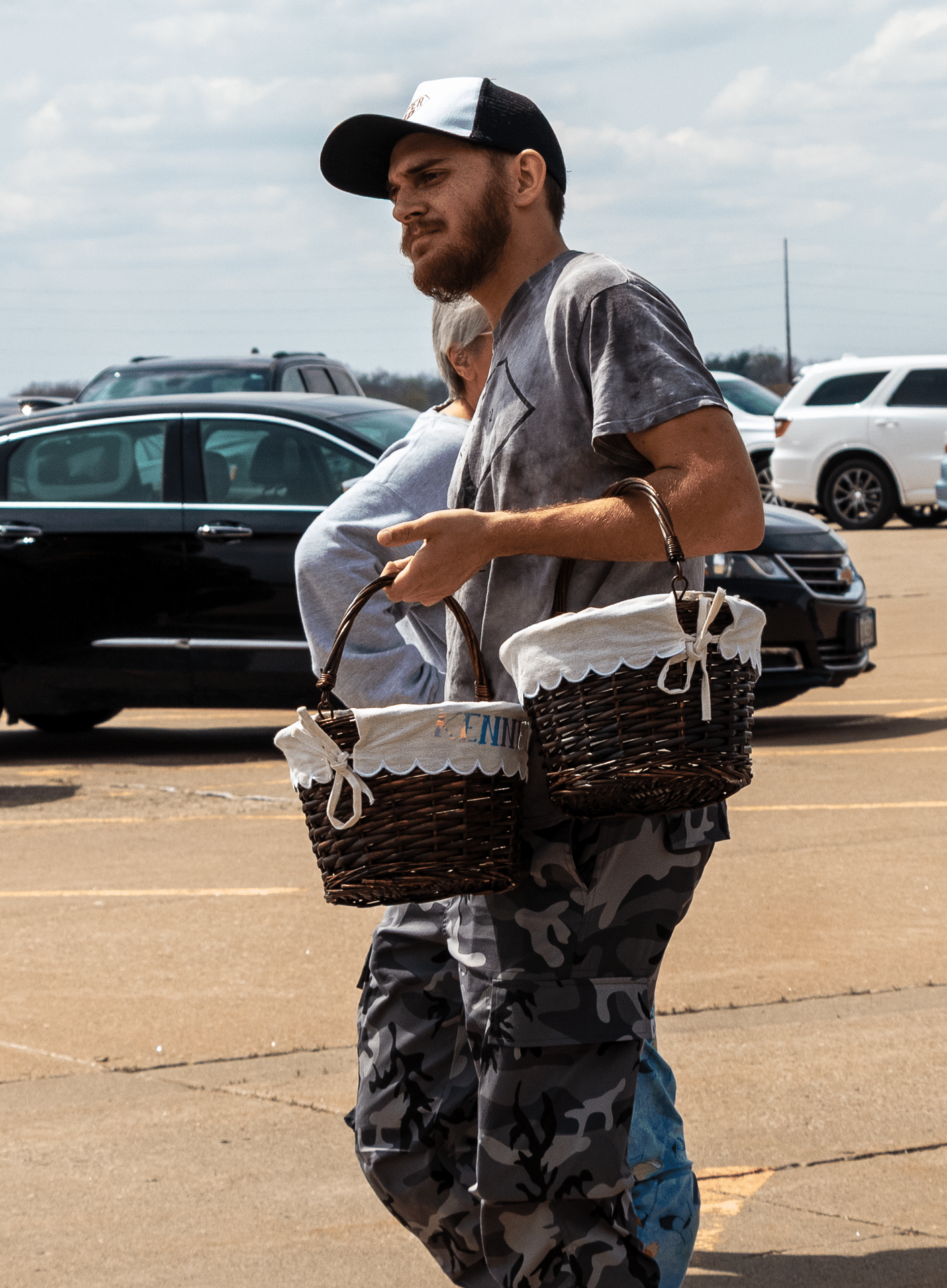 A neighbor carrying baskets in our parking lot, sharing hope and welcoming hearts at Muscatine Church of Christ. - Muscatine Church of Christ