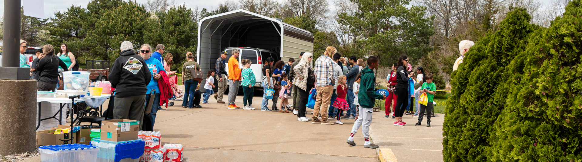 Neighbors of all ages gather outside, sharing supplies and hope—welcome to our caring Muscatine Church family. - Muscatine Church of Christ