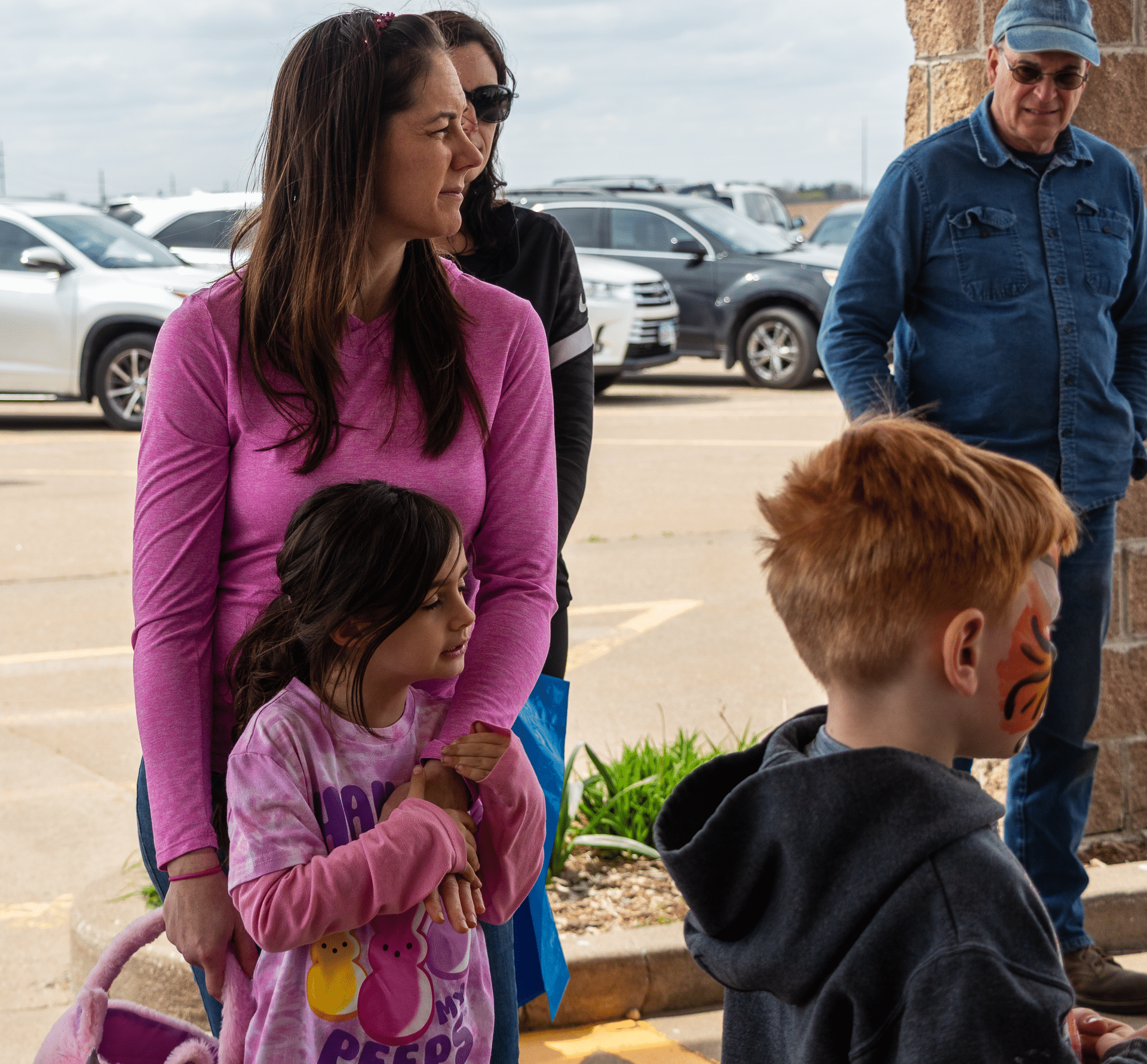 A smiling woman and girl enjoy time together outside as laughter and friendly faces fill our church family gathering. - Muscatine Church of Christ