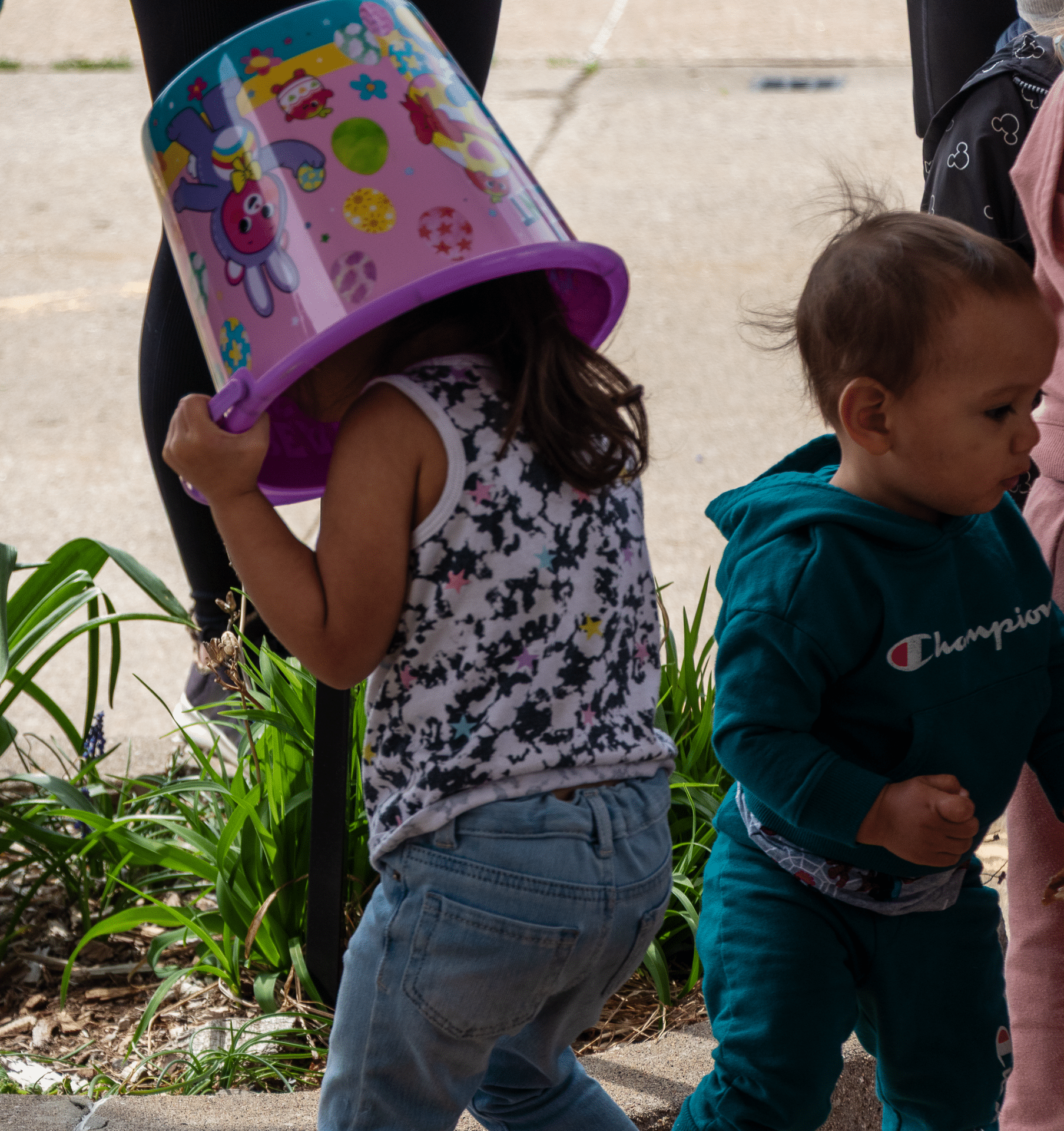Two children play together outside, sharing smiles and hope—reminding us of God’s joyful, welcoming love. - Muscatine Church of Christ