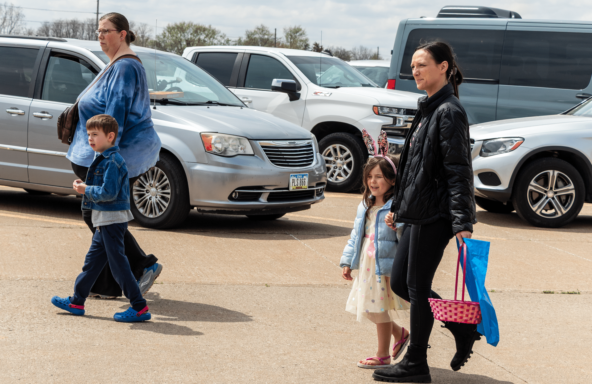 Two women and children walk together on a cloudy day, sharing hope and welcome in our church family. - Muscatine Church of Christ